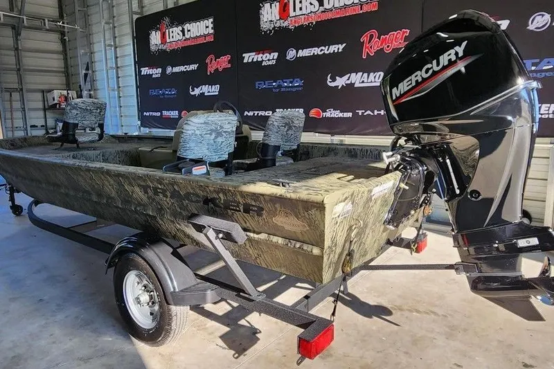 Slide: The Image of 2026 Tracker Grizzly 1754 SC boat with Mercury engine in showroom. - 3