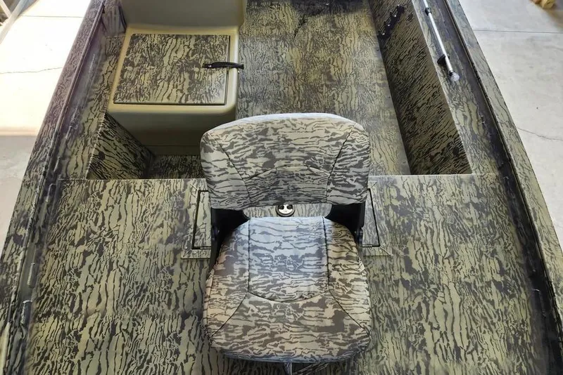 Slide: The Image of 2026 Tracker Grizzly 1754 SC boat interior with camouflage seating and flooring design. - 4