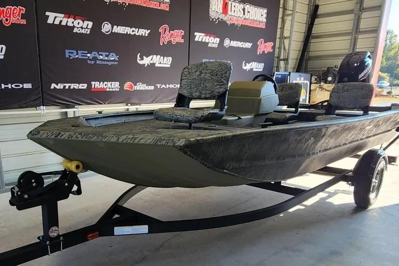 Slide: The Image of 2026 Tracker Grizzly 1754 SC boat on trailer in showroom setting. - 9