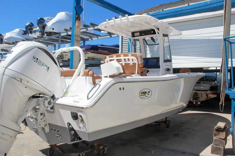 The Image of 2024 Sea Hunt Ultra 255 SE boat with Yamaha engine in a marina setting. - 0