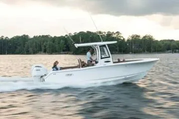 Slide: The Image of 2024 Sea Hunt Ultra 255 SE boat console with steering wheel and controls. - 14