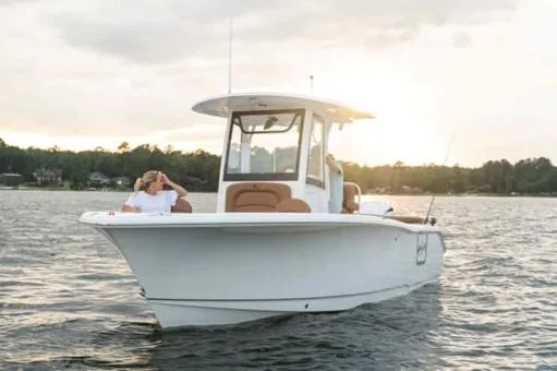 Slide: The Image of 2024 Sea Hunt Ultra 255 SE boat storage compartment with open door, showcasing interior space. - 18