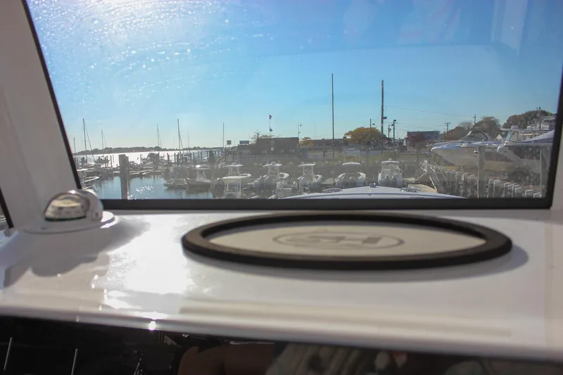 Slide: The Image of 2024 Sea Hunt Ultra 255 SE boat view from cabin, overlooking marina. - 21