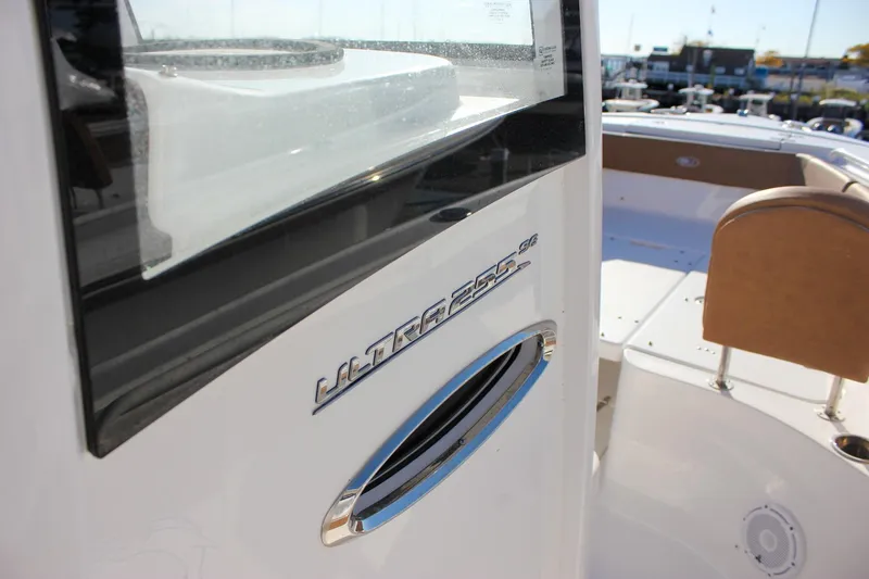 Slide: The Image of 2024 Sea Hunt Ultra 255 SE boat, close-up of sleek design and seating area. - 22