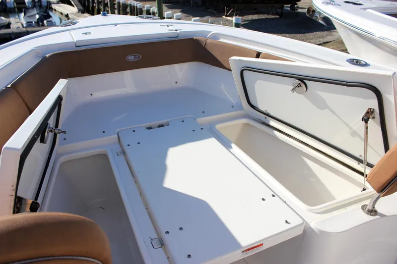 Slide: The Image of 2024 Sea Hunt Ultra 255 SE boat interior with open storage compartments. - 24
