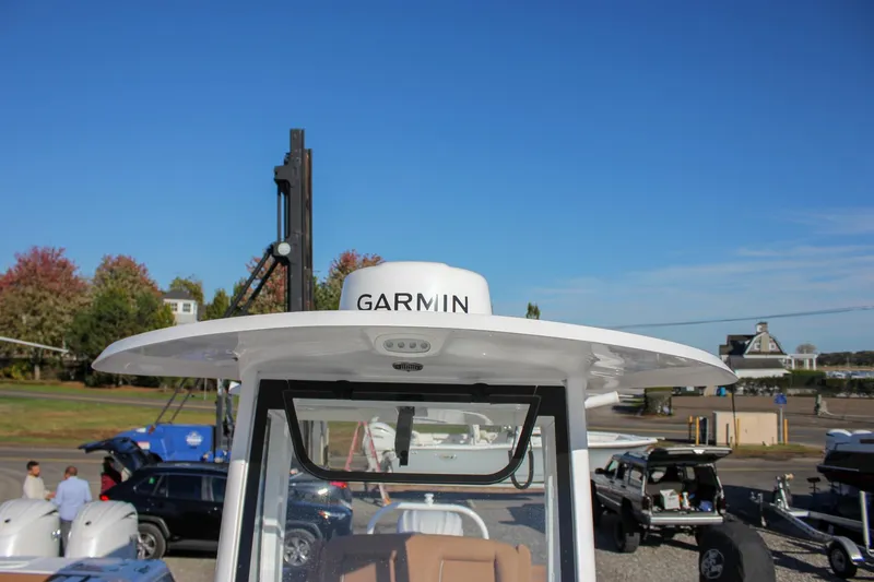 Slide: The Image of 2024 Sea Hunt Ultra 255 SE boat with Garmin equipment, docked under clear blue sky. - 26