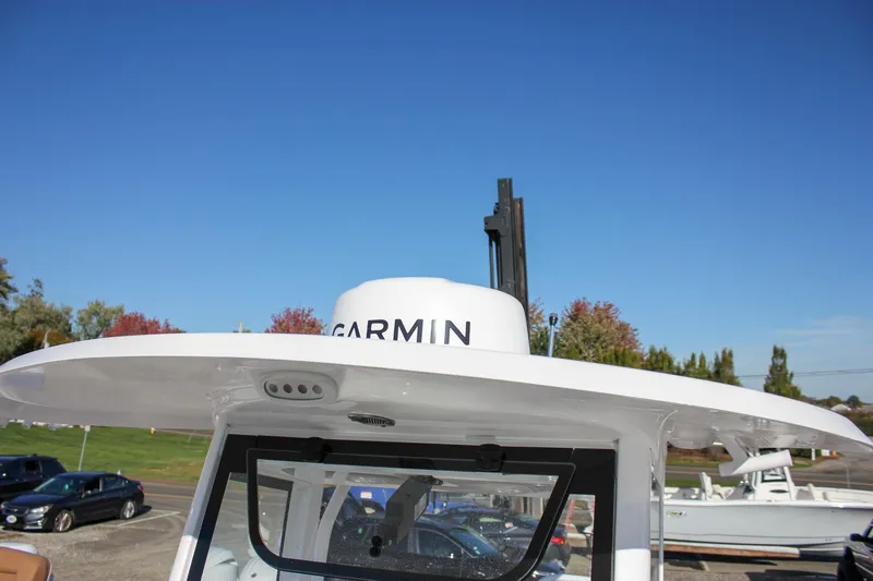 Slide: The Image of 2024 Sea Hunt Ultra 255 SE boat with Garmin radar, clear blue sky background. - 27