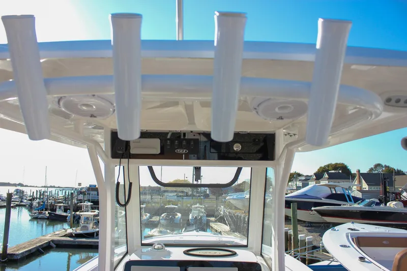 Slide: The Image of 2024 Sea Hunt Ultra 255 SE boat console with rod holders at marina. - 28