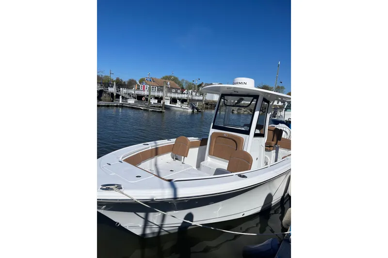 Slide: The Image of 2024 Sea Hunt Ultra 255 SE boat on display, rear view with outboard motor. - 3