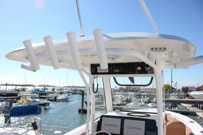 Slide: The Image of 2024 Sea Hunt Ultra 255 SE boat with rod holders and Garmin electronics at marina. - 30