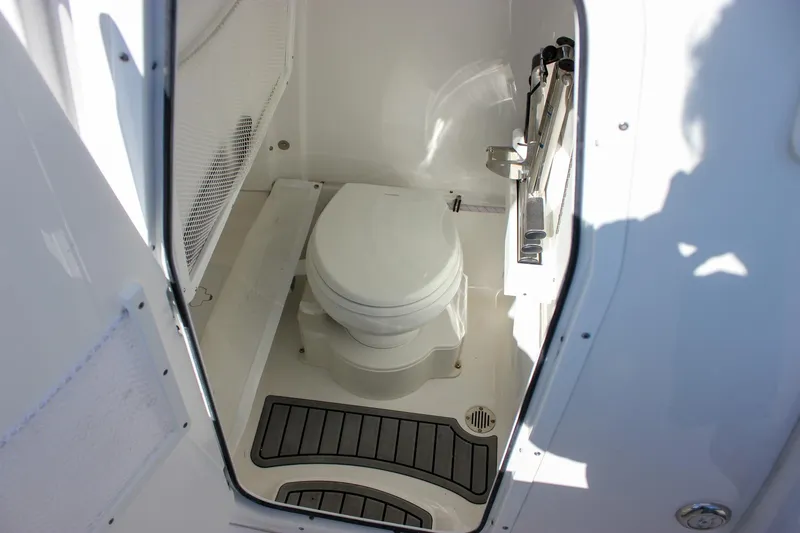 Slide: The Image of 2024 Sea Hunt Ultra 255 SE boat interior with compact marine toilet. - 37