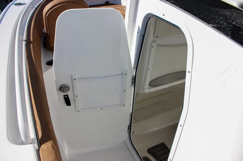 Slide: The Image of 2024 Sea Hunt Ultra 255 SE boat interior with open storage compartment. - 38