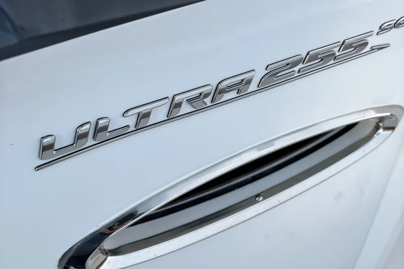 Slide: The Image of 2024 Sea Hunt Ultra 255 SE boat interior with brown seating and marina view. - 4