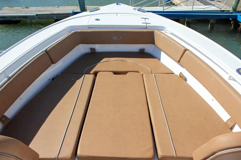 Slide: The Image of 2024 Sea Hunt Ultra 255 SE boat with spacious tan seating area. - 42