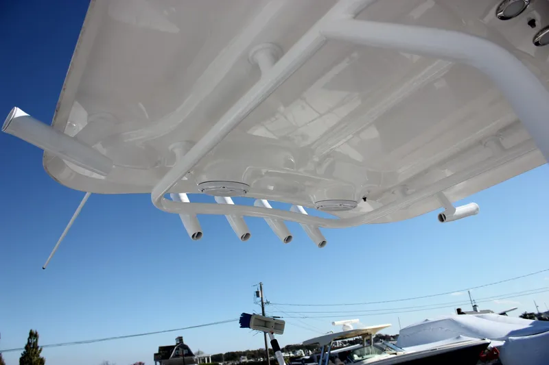 Slide: The Image of 2024 Sea Hunt Ultra 255 SE boat canopy with rod holders against clear sky. - 45