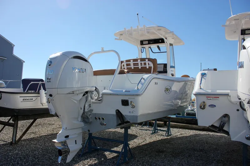 Slide: The Image of 2024 Sea Hunt Ultra 255 SE boat with Yamaha 300 V6 engine displayed outdoors. - 50