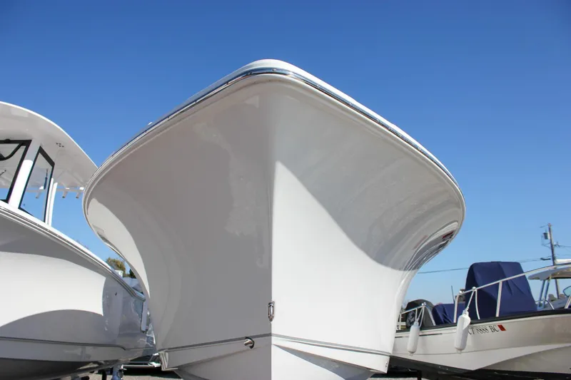 Slide: The Image of 2024 Sea Hunt Ultra 255 SE boat under clear blue sky. - 51