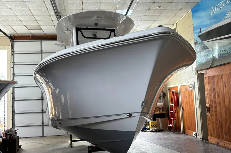 Slide: The Image of 2024 Sea Hunt Ultra 255 SE boat with Yamaha engines, docked outdoors. - 7