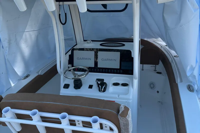 Slide: The Image of 2024 Sea Hunt Ultra 255 SE boat interior with storage compartments and seating. - 8