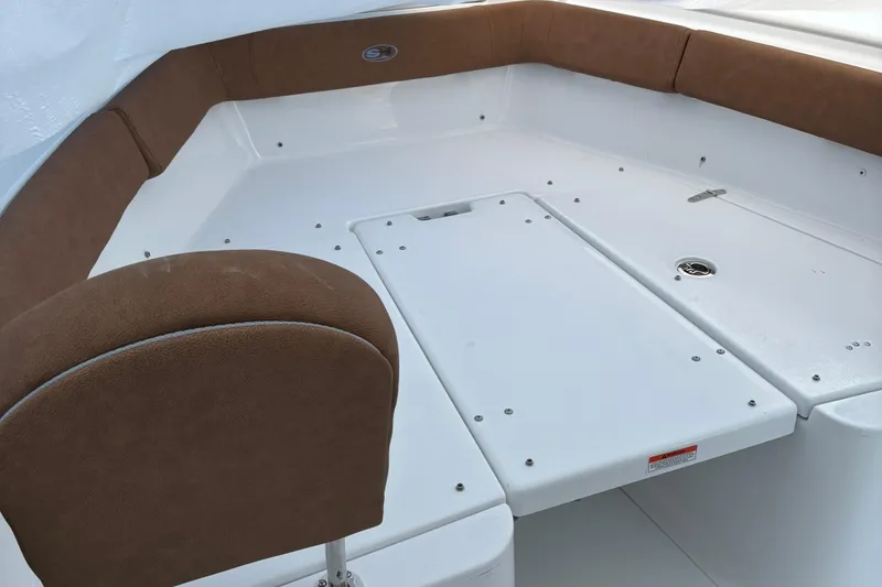 Slide: The Image of 2024 Sea Hunt Ultra 255 SE boat interior with cushioned seating and storage compartments. - 9