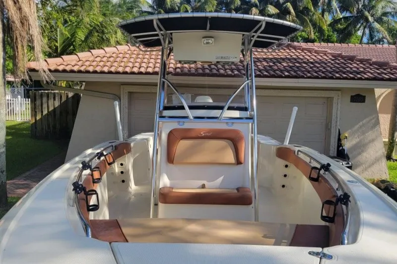Slide: The Image of 2003 Scout 242 Sportfish boat on trailer, parked outdoors near power lines. - 1