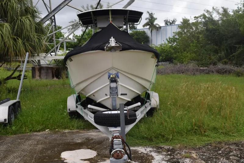 Slide: The Image of 2003 Scout 242 Sportfish boat interior with tan seating and storage compartment. - 10