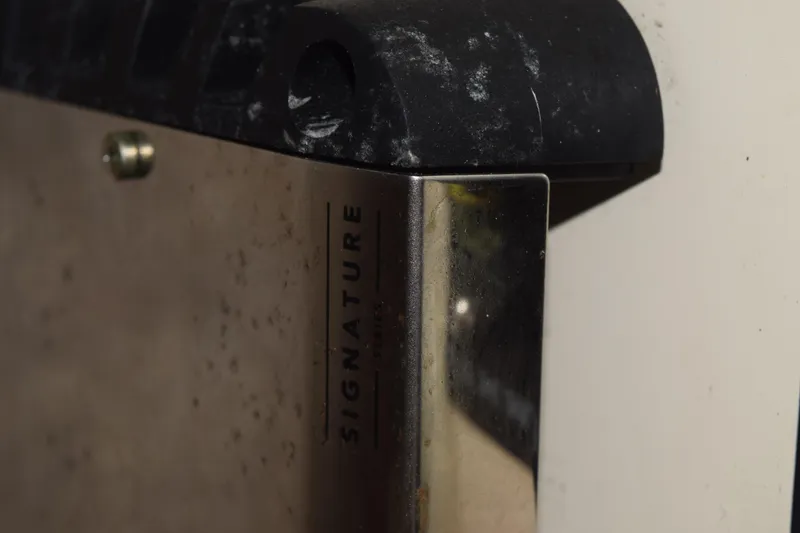 Slide: The Image of Control panel of a 2003 Scout 242 Sportfish boat with compass and radio. - 101