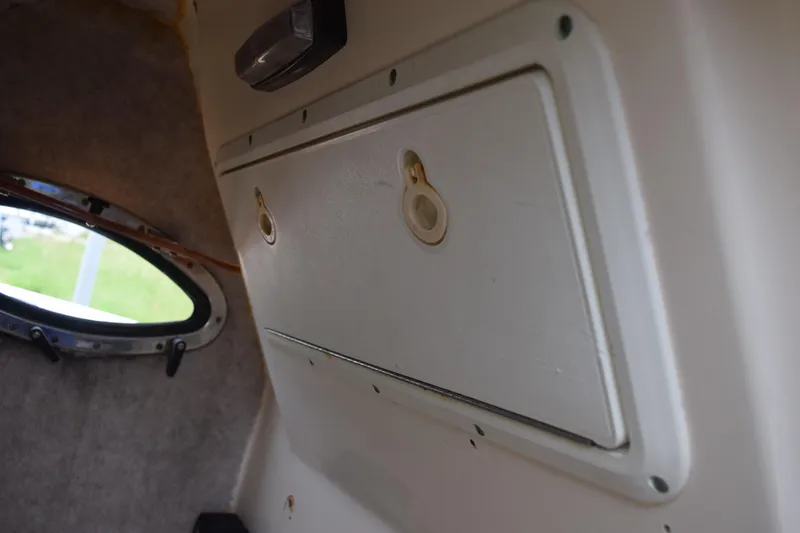 Slide: The Image of Control panel of a 2003 Scout 242 Sportfish boat with switches and a microphone. - 102