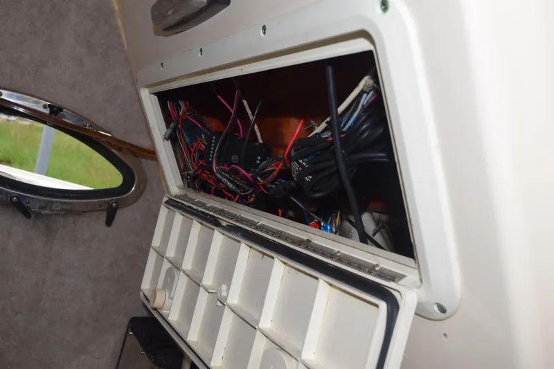 Slide: The Image of White storage compartment on 2003 Scout 242 Sportfish boat dashboard. - 103