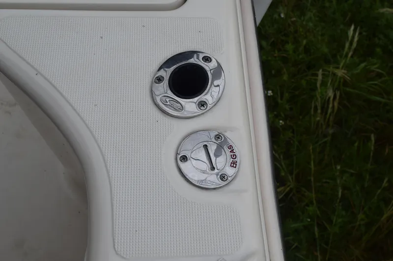 Slide: The Image of Steering wheel and controls of a 2003 Scout 242 Sportfish boat. - 108