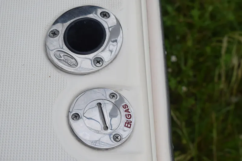 Slide: The Image of Control panel of a 2003 Scout 242 Sportfish boat with Suzuki and Lenco switches. - 109