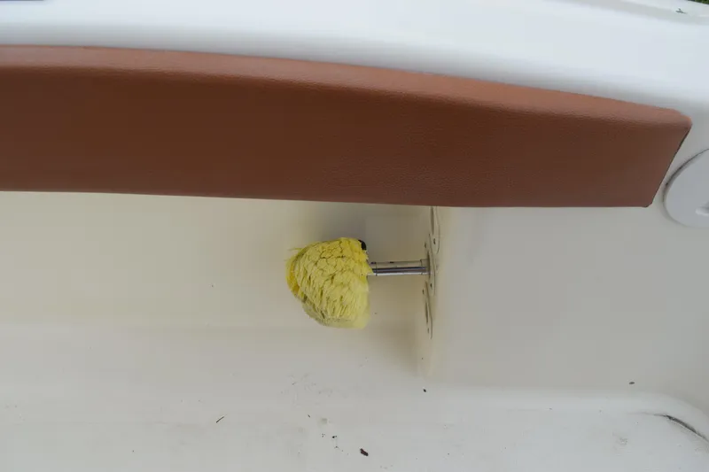 Slide: The Image of 2003 Scout 242 Sportfish boat with metal framework and palm trees in the background. - 116