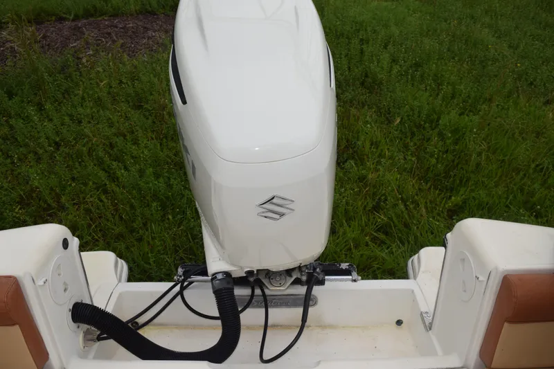 Slide: The Image of 2003 Scout 242 Sportfish boat canopy with rod holders against cloudy sky. - 117