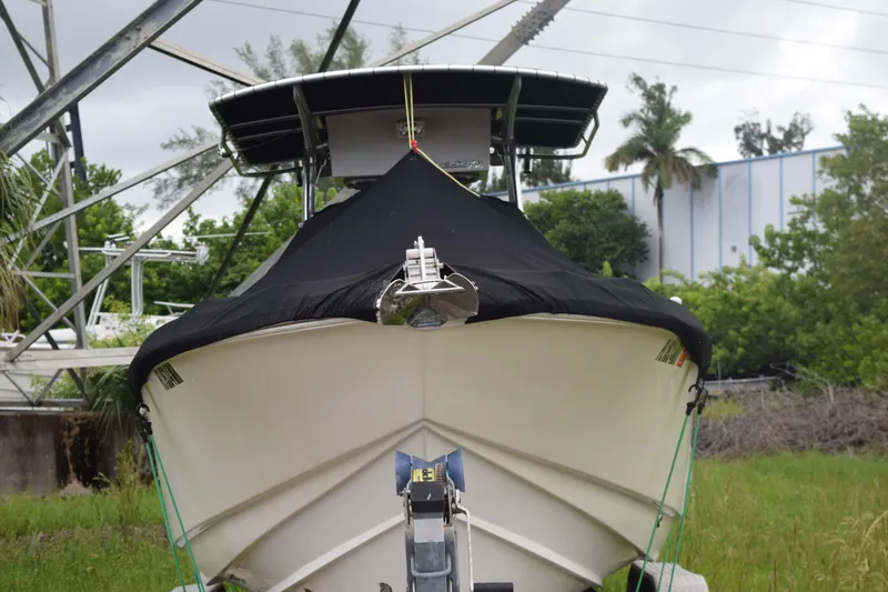 Slide: The Image of 2003 Scout 242 Sportfish boat deck with trees in the background. - 12