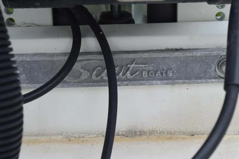 Slide: The Image of Rod holders on a 2003 Scout 242 Sportfish boat, featuring chrome and white accents. - 120