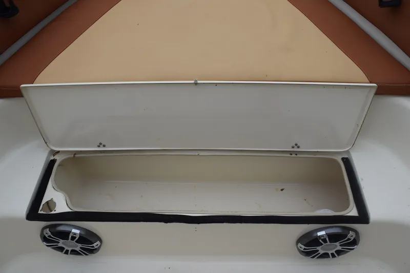 Slide: The Image of 2003 Scout 242 Sportfish boat compartment, showing interior details and drainage. - 122