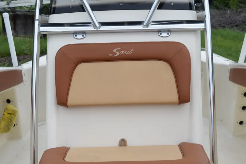 Slide: The Image of Brown and beige seating on 2003 Scout 242 Sportfish boat, with Suzuki engine visible. - 127