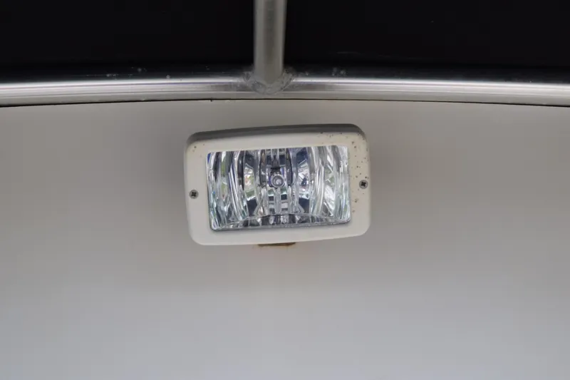 Slide: The Image of 2003 Scout 242 Sportfish boat interior with steering wheel and control panel. - 132