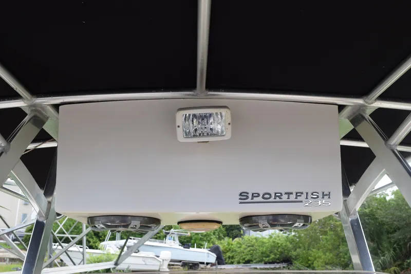 Slide: The Image of 2003 Scout 242 Sportfish boat with rod holders and canopy frame. - 133