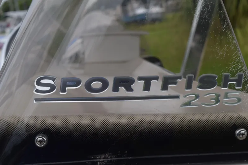 Slide: The Image of Close-up of a 2003 Scout 242 Sportfish boat's metal rod holders and light fixture. - 136