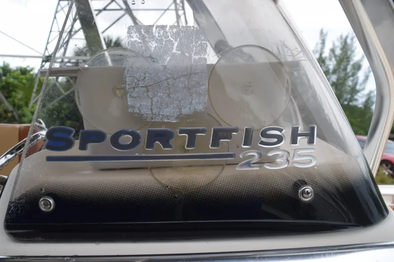 Slide: The Image of 2003 Scout 242 Sportfish boat interior with steering wheel and control panel. - 138