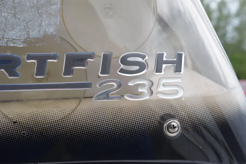 Slide: The Image of 2003 Scout 242 Sportfish boat dashboard with steering wheel and controls. - 139