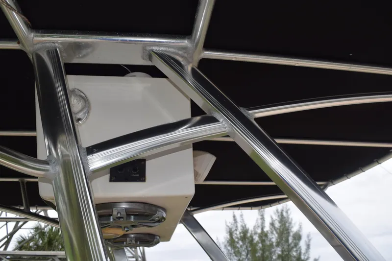 Slide: The Image of Suzuki outboard motor on 2003 Scout 242 Sportfish boat, with palm trees in background. - 141