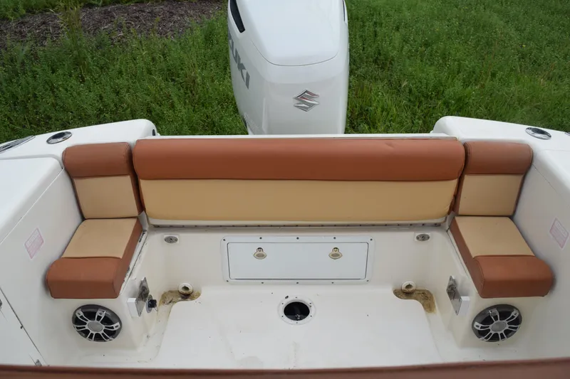 Slide: The Image of Outboard motor of 2003 Scout 242 Sportfish on grassy field. - 142
