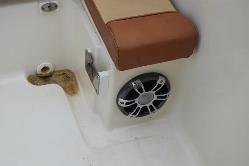 Slide: The Image of Outboard motor of a 2003 Scout 242 Sportfish on grassy terrain. - 144