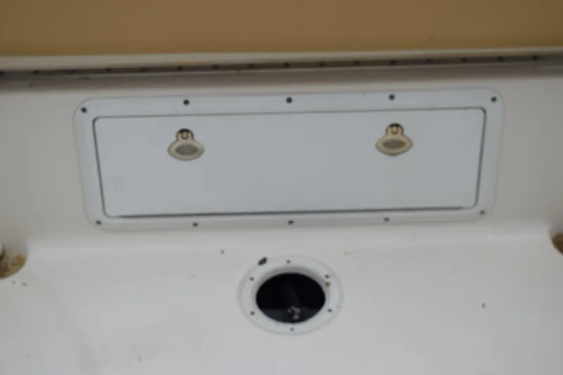 Slide: The Image of 2003 Scout 242 Sportfish boat with Suzuki outboard motor in grassy area. - 145