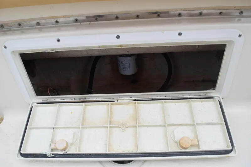 Slide: The Image of Rear view of a 2003 Scout 242 Sportfish boat propeller on grass. - 148