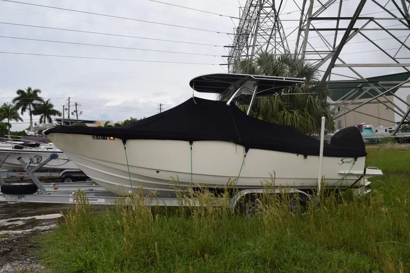 Slide: The Image of 2003 Scout 242 Sportfish boat deck with storage compartment and seating. - 15