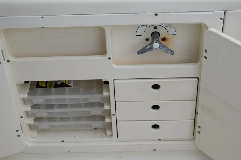 Slide: The Image of 2003 Scout 242 Sportfish boat stern with ladder, parked on grass. - 153