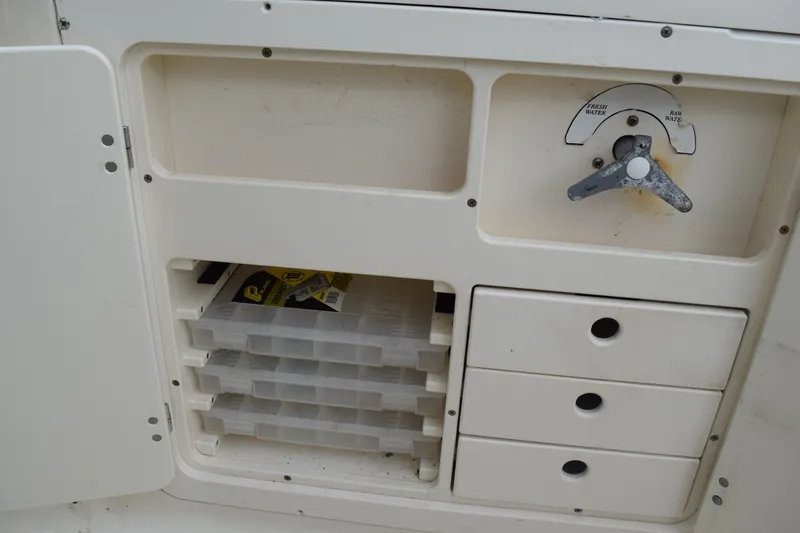 Slide: The Image of 2003 Scout 242 Sportfish boat with Suzuki outboard motor on trailer. - 154